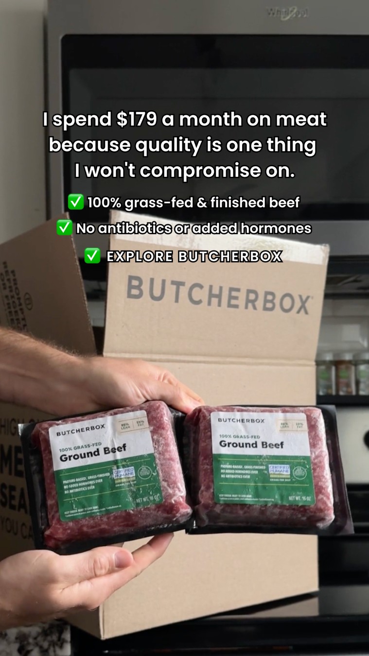 ButcherBox unboxing photo with two meat packs held in front of an open box.